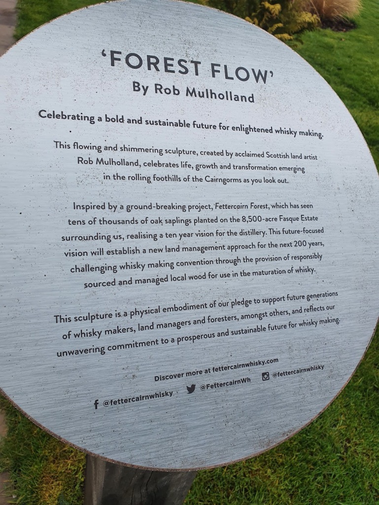 Plaque explaining the vision for the distillery and the sculpture that was commissioned to celebrate the tree planting.