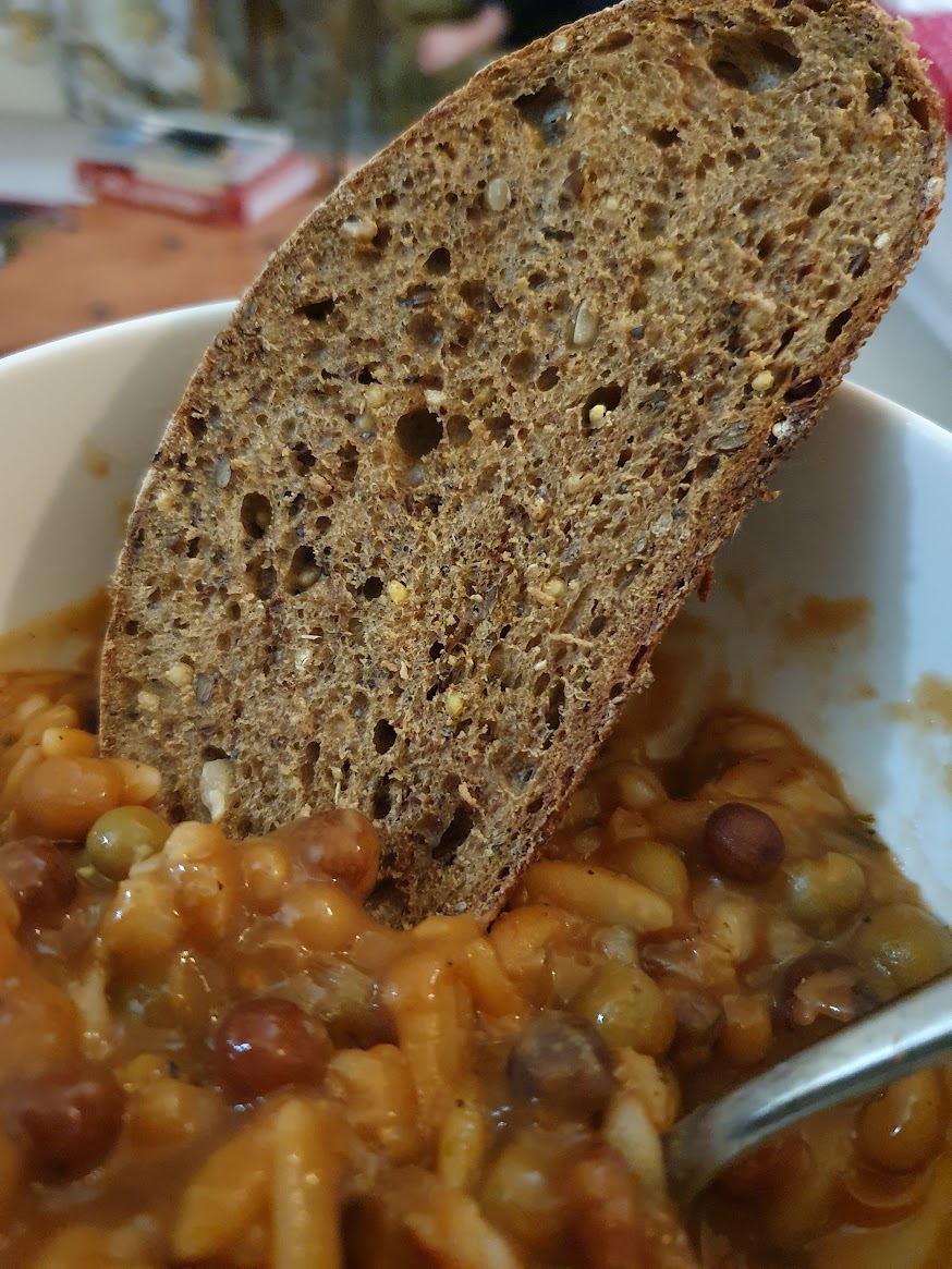 Sourdough bread in a bowl of soup.